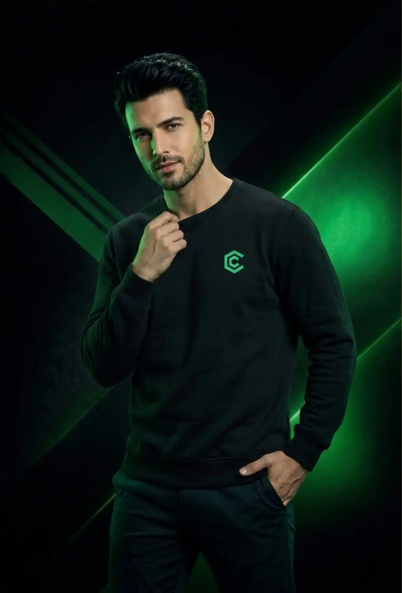 Man wearing a black sweatshirt with a green logo against a dark background