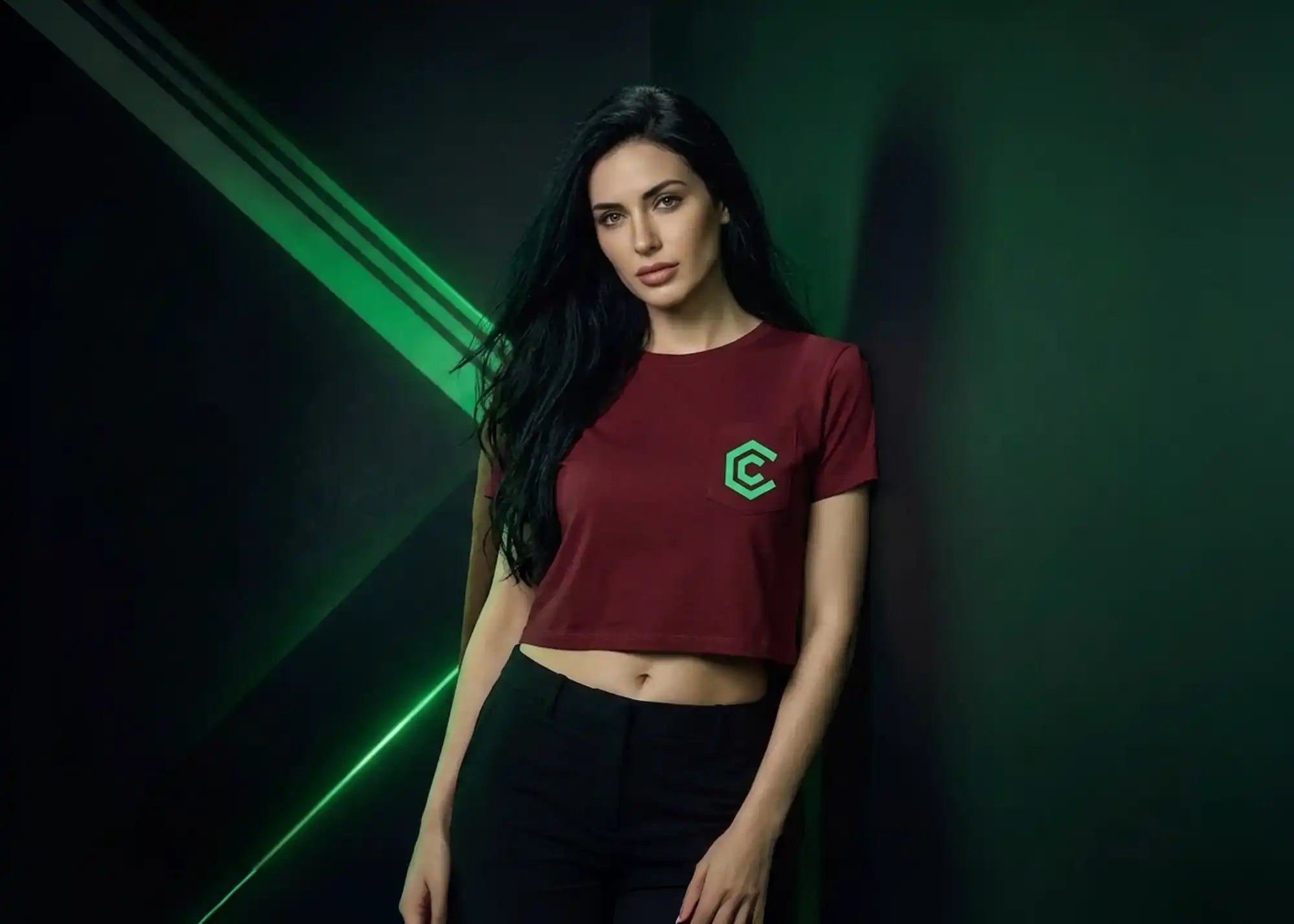 Woman wearing a red t-shirt with a green logo against a dark background