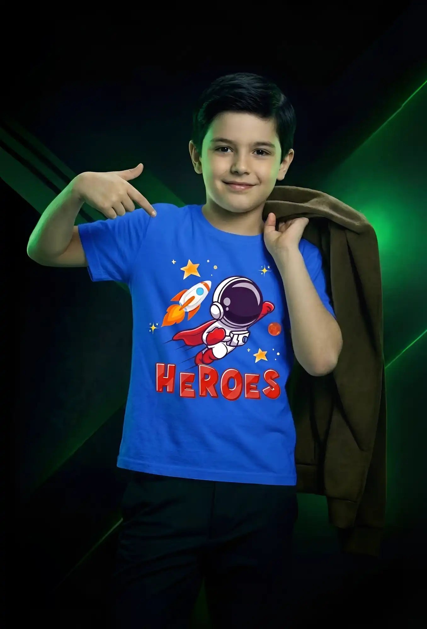 Child wearing a blue t-shirt with a superhero design and 'HEROES' text on a dark background