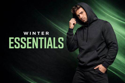 Person wearing a black hoodie with 'Winter Essentials' text on a dark green background